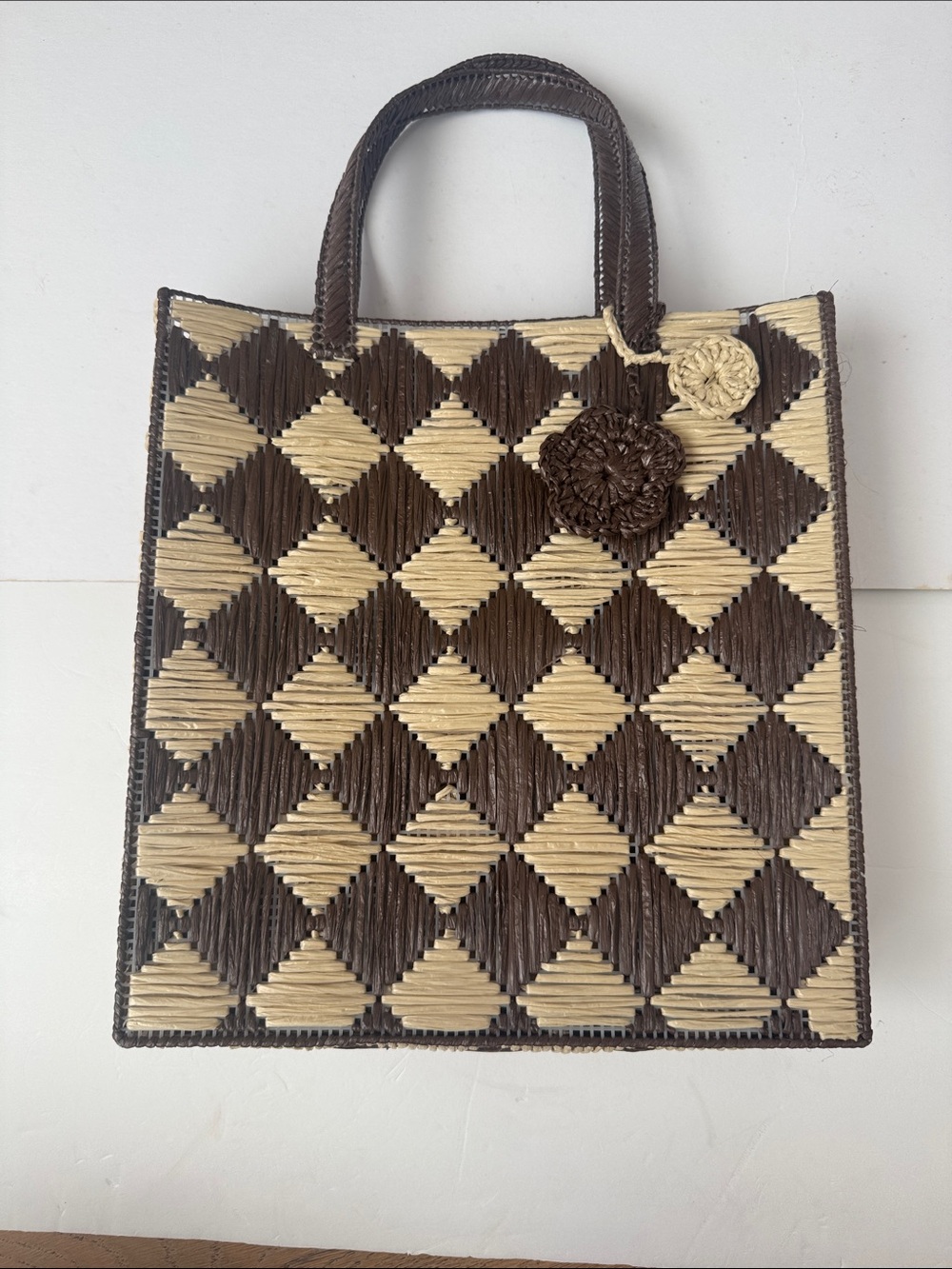 brown and beige woven tote bag with a geometric diamond pattern